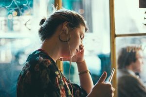 Woman with Headphones Staring at Exam